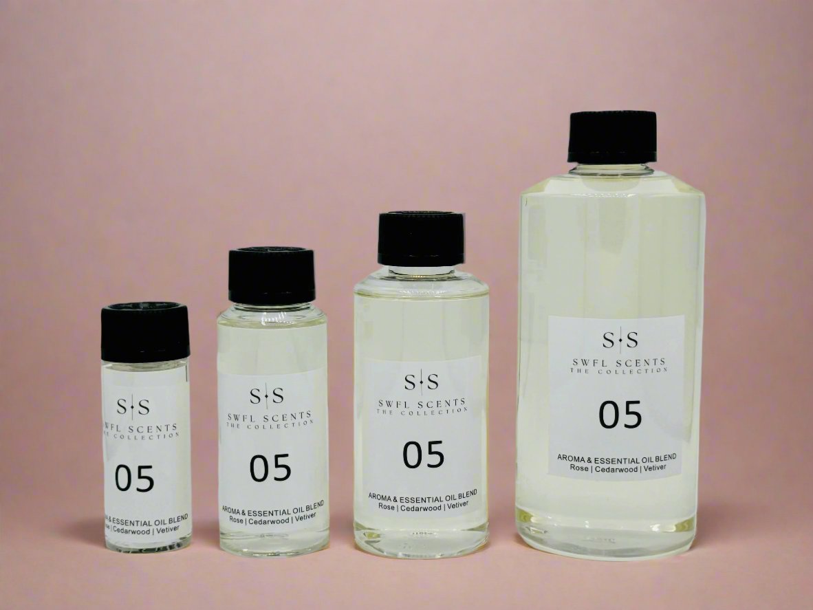 Four bottles of SWFL Scents essential oil blend labeled "05" in various sizes displayed in a row.